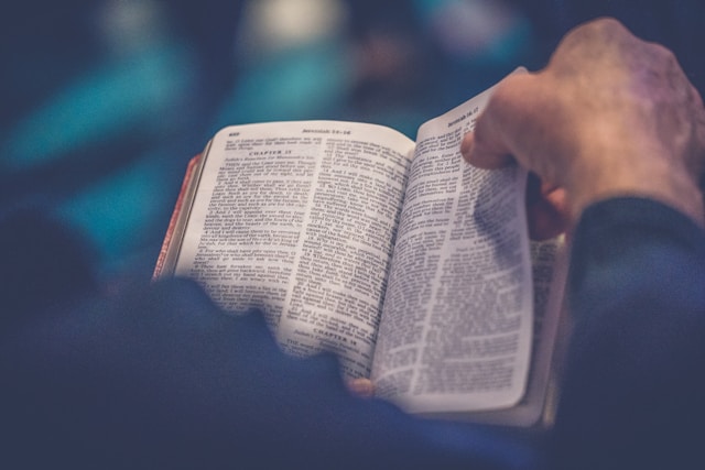 person holding bible turning page