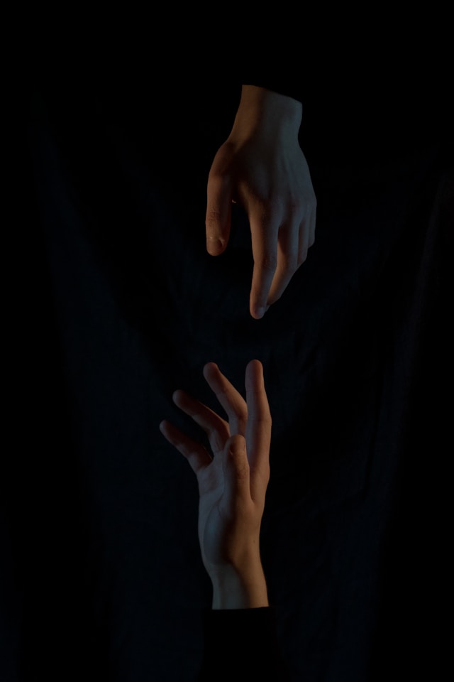 two hands reaching for each other