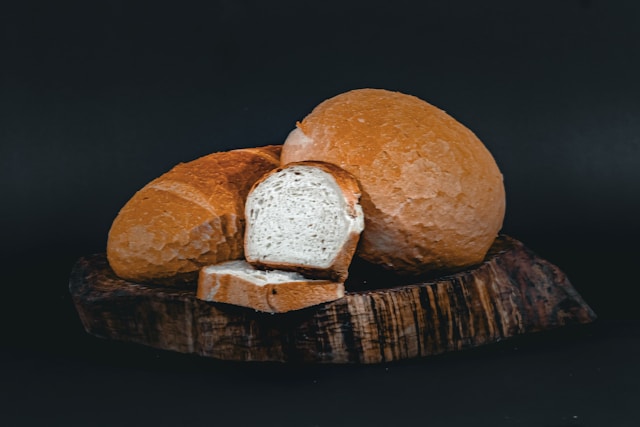 A small amount of yeast being mixed into a large lump of dough